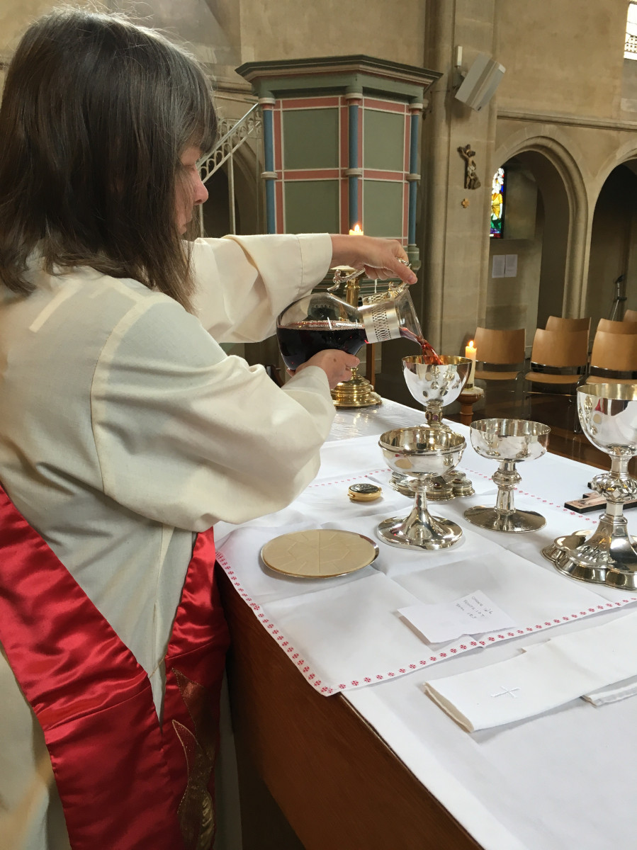 Deacon prepares altar table for Holy Communion